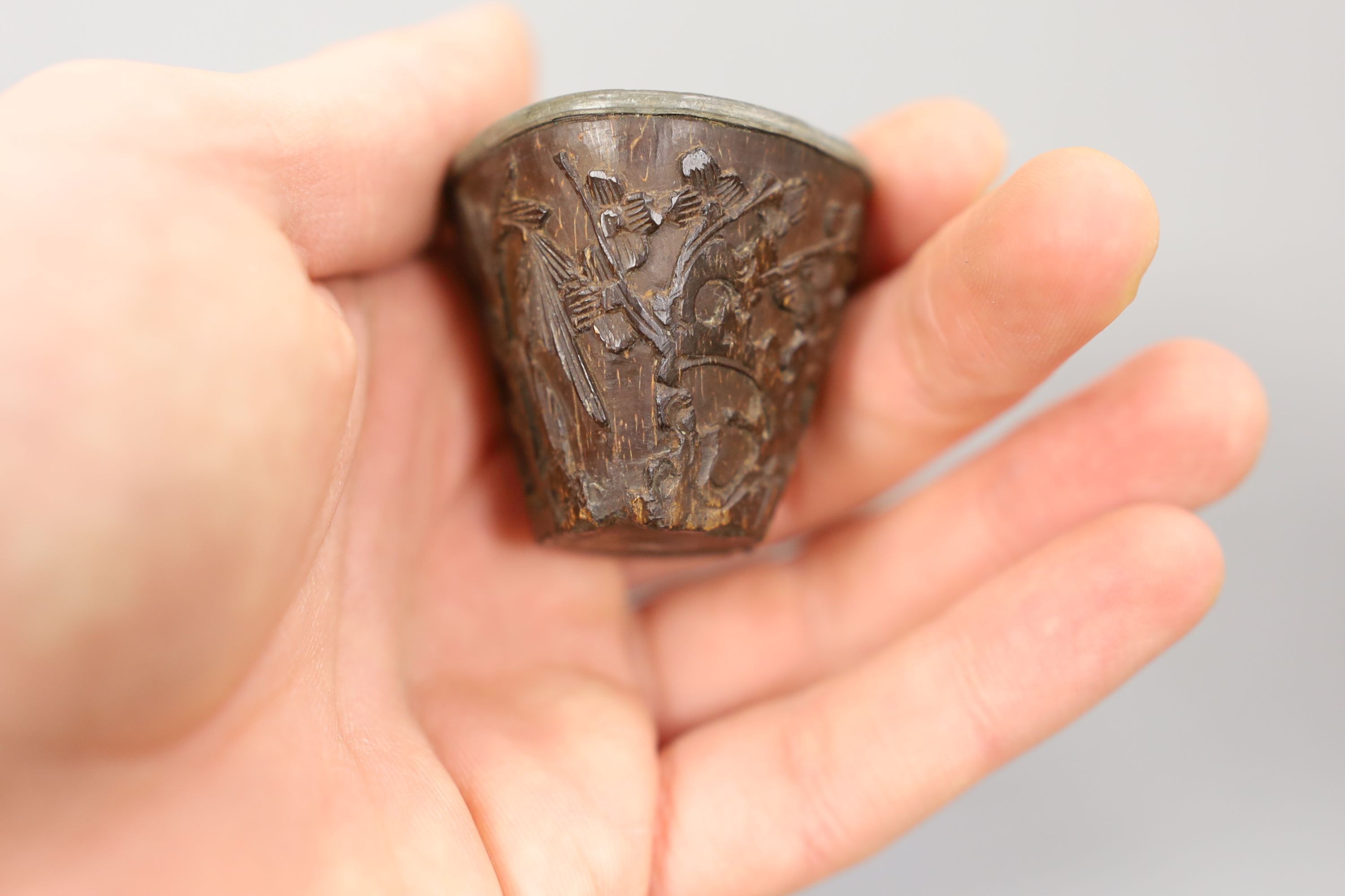 A Chinese or Japanese ivory lion dog 18th/19th century and a Chinese carved nut cup, 19th century. 4cm